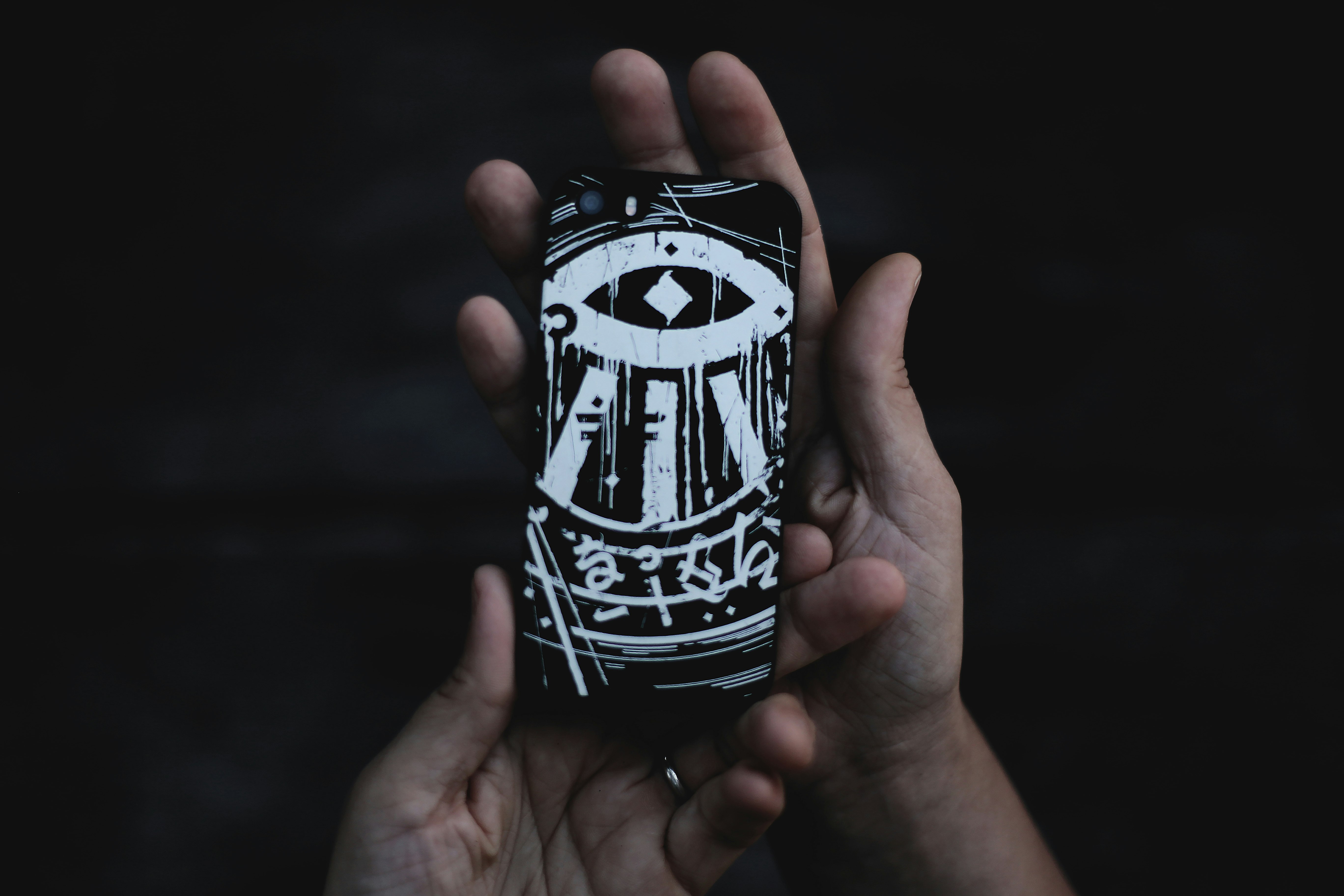 person holding black and white phone case